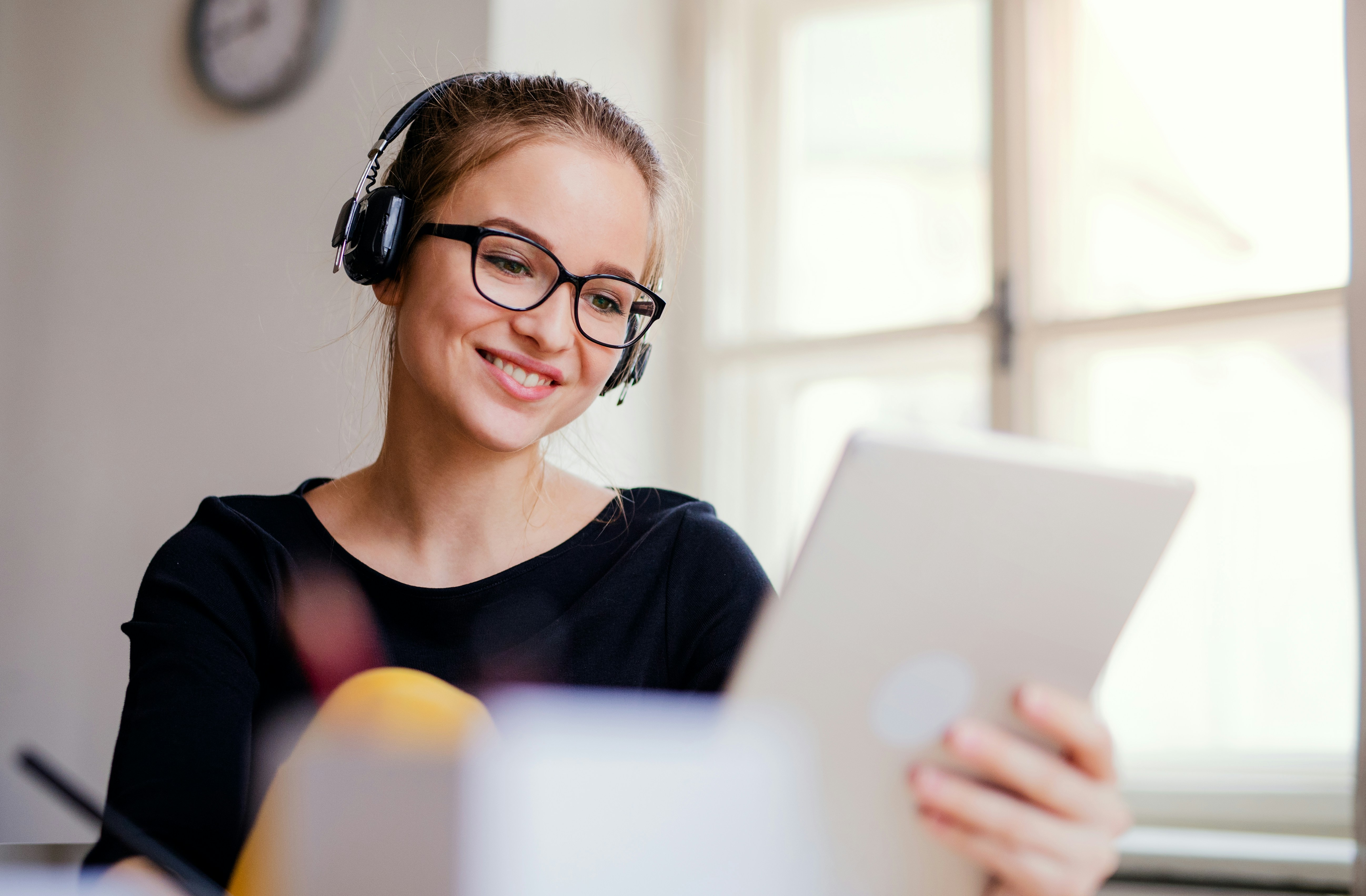 Successful online tutor using a headset and tablet while scaling an online tutoring business with a virtual classroom.