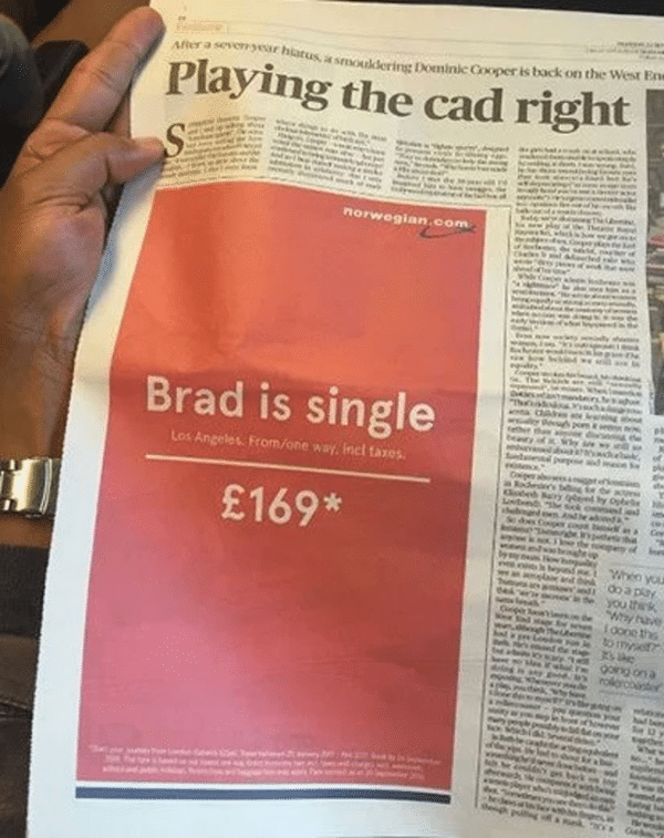 Newspaper article about hollywood Brad is single in pink background