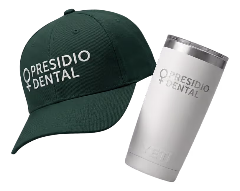 Black fitness tracker, green folded jacket with white earphones, and black massage gun labeled Theragun Prime.