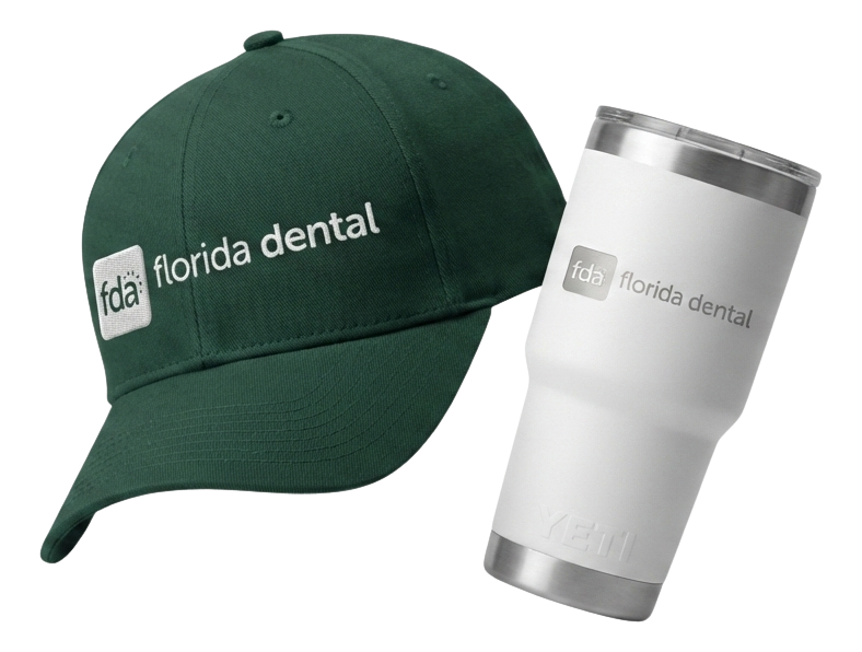 Black fitness tracker, green folded jacket with white earphones, and black massage gun labeled Theragun Prime.