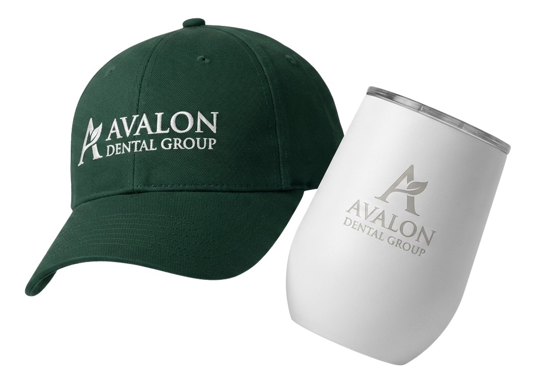 Black fitness tracker, green folded jacket with white earphones, and black massage gun labeled Theragun Prime.