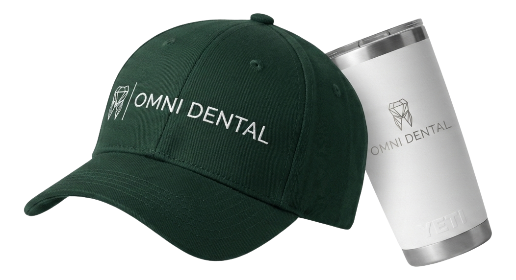 Black fitness tracker, green folded jacket with white earphones, and black massage gun labeled Theragun Prime.