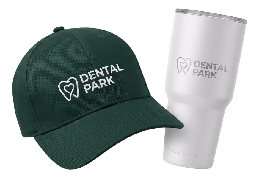 Black fitness tracker, green folded jacket with white earphones, and black massage gun labeled Theragun Prime.