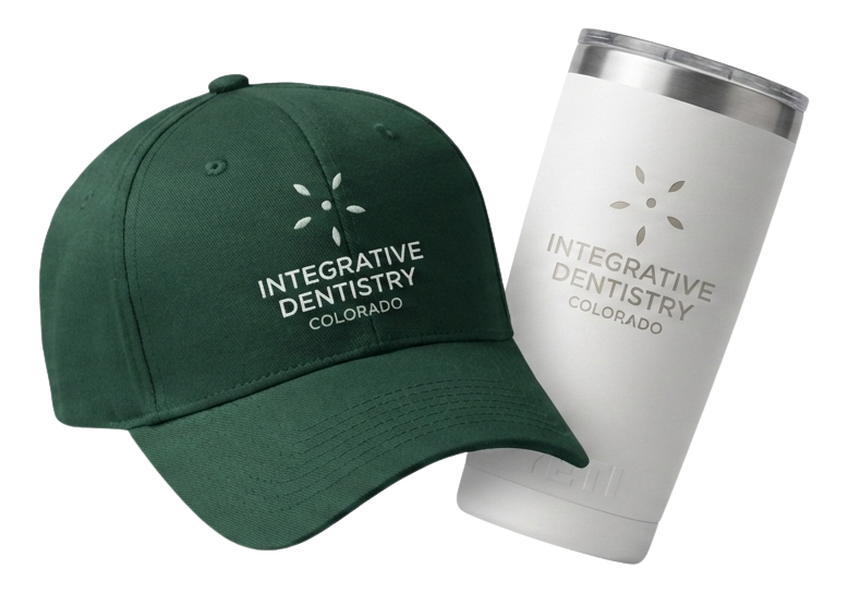 Black fitness tracker, green folded jacket with white earphones, and black massage gun labeled Theragun Prime.