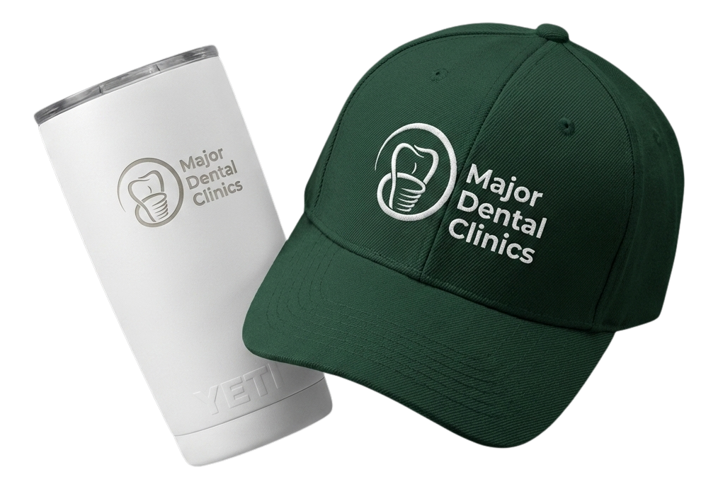 Black fitness tracker, green folded jacket with white earphones, and black massage gun labeled Theragun Prime.