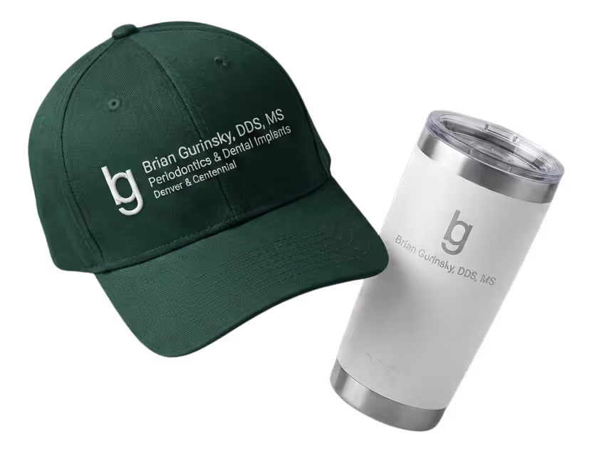 Black fitness tracker, green folded jacket with white earphones, and black massage gun labeled Theragun Prime.