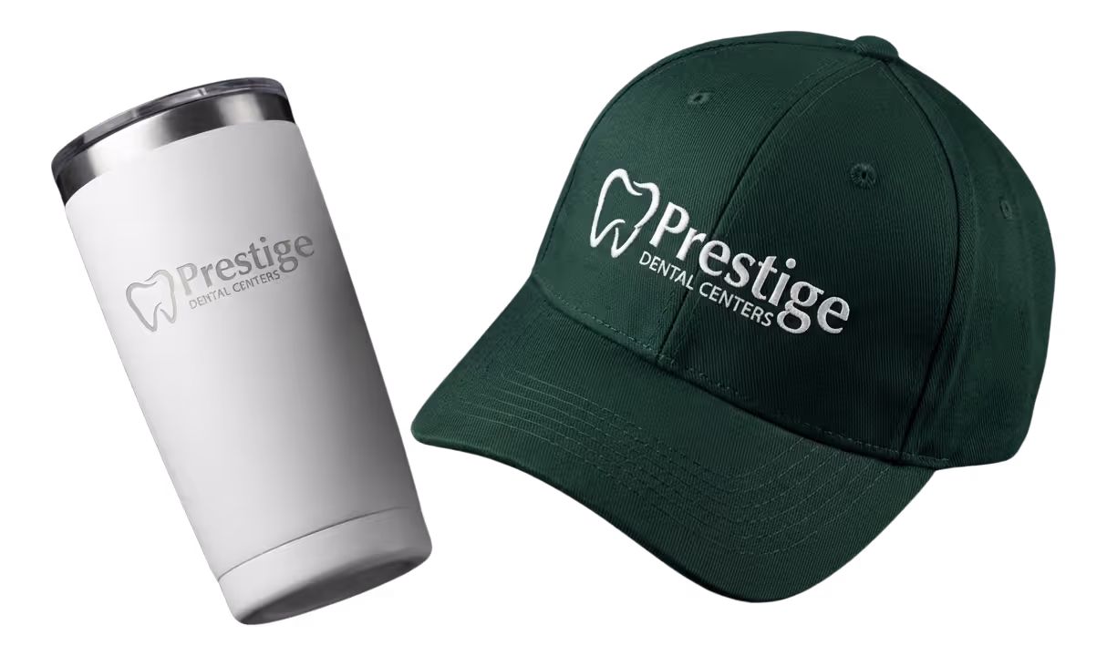 Black fitness tracker, green folded jacket with white earphones, and black massage gun labeled Theragun Prime.