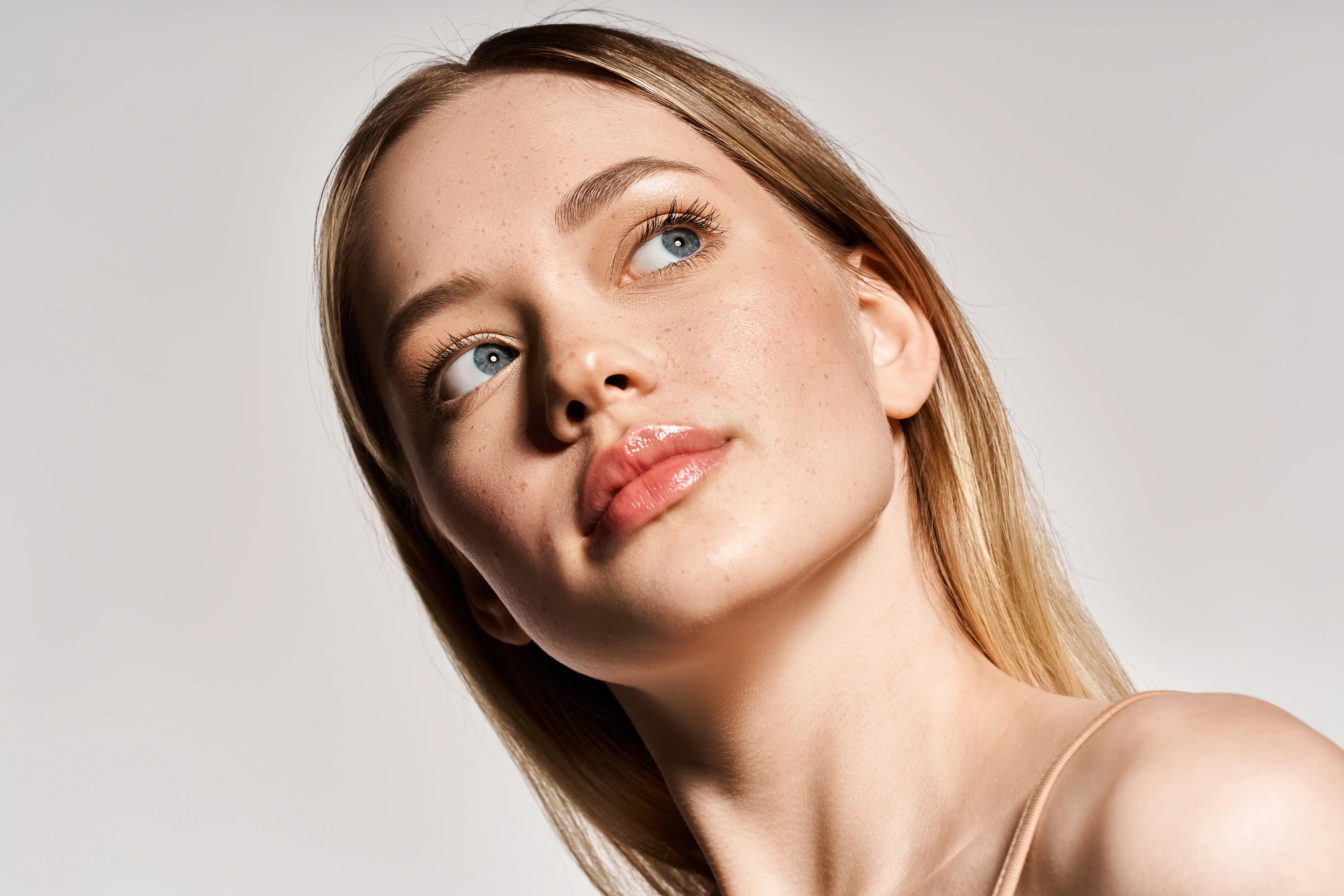 A woman with blue eyes is posing for a picture.