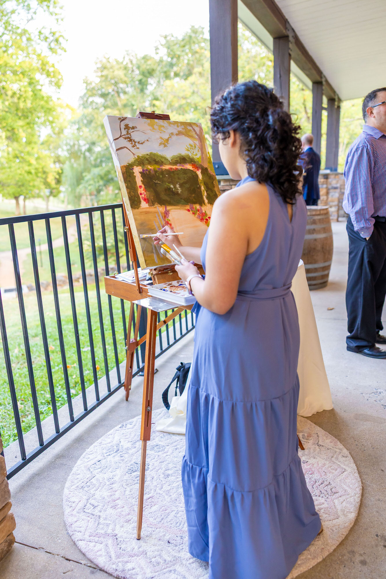 Live wedding painter creating a ceremony painting during cocktail hour at a Charlottesville vineyard wedding venue in Virginia.