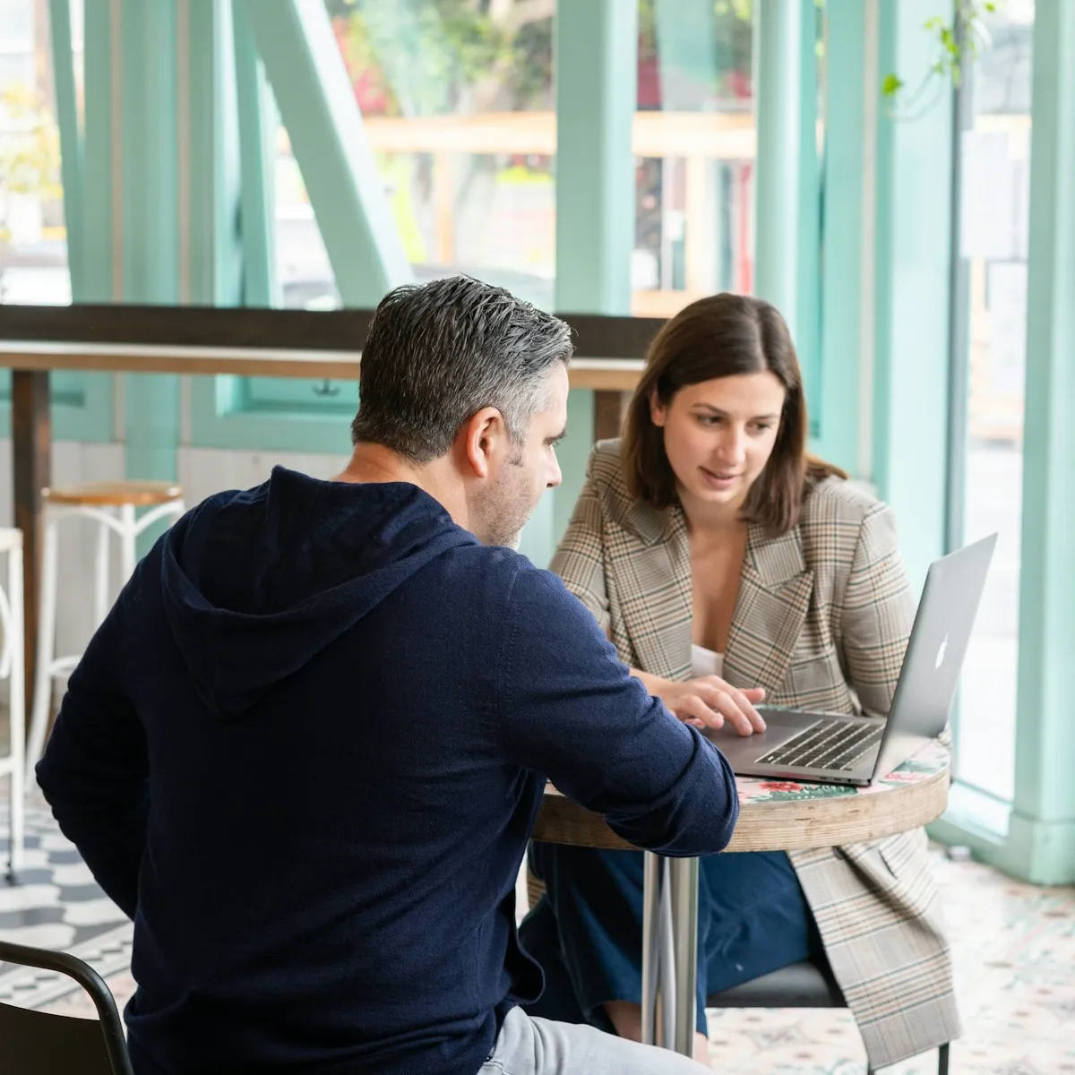 Two people looking at a laptop 