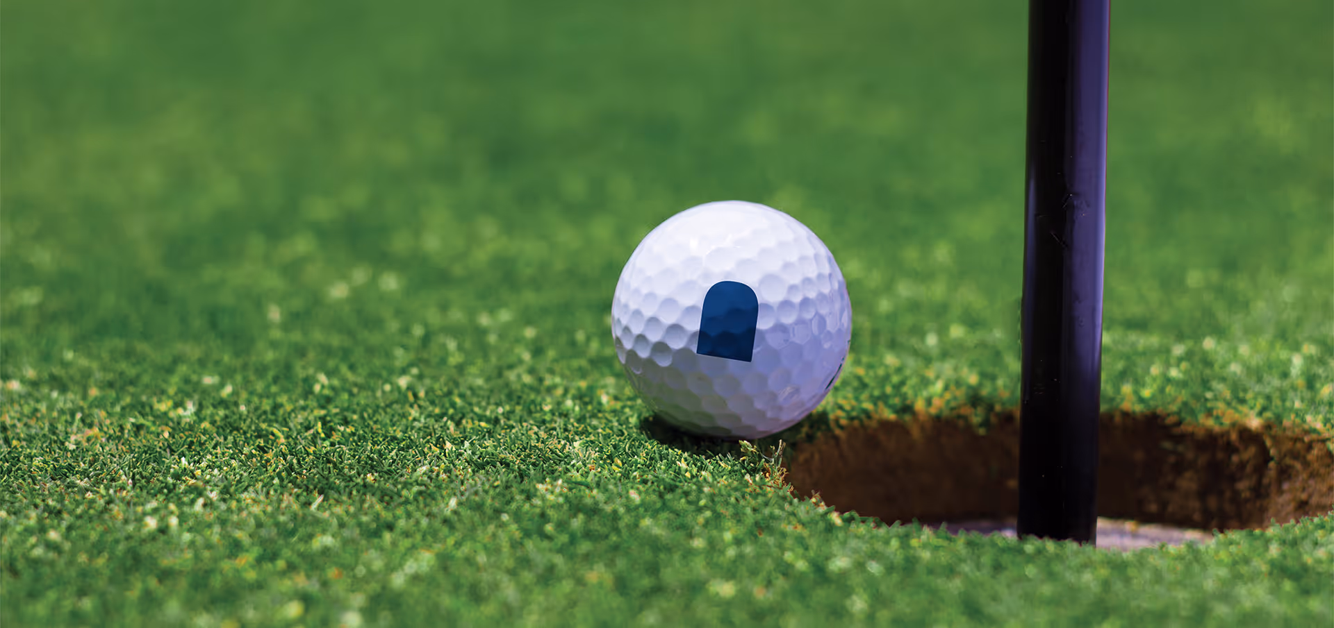 Custom logo on a golfball on the edge of the hole.