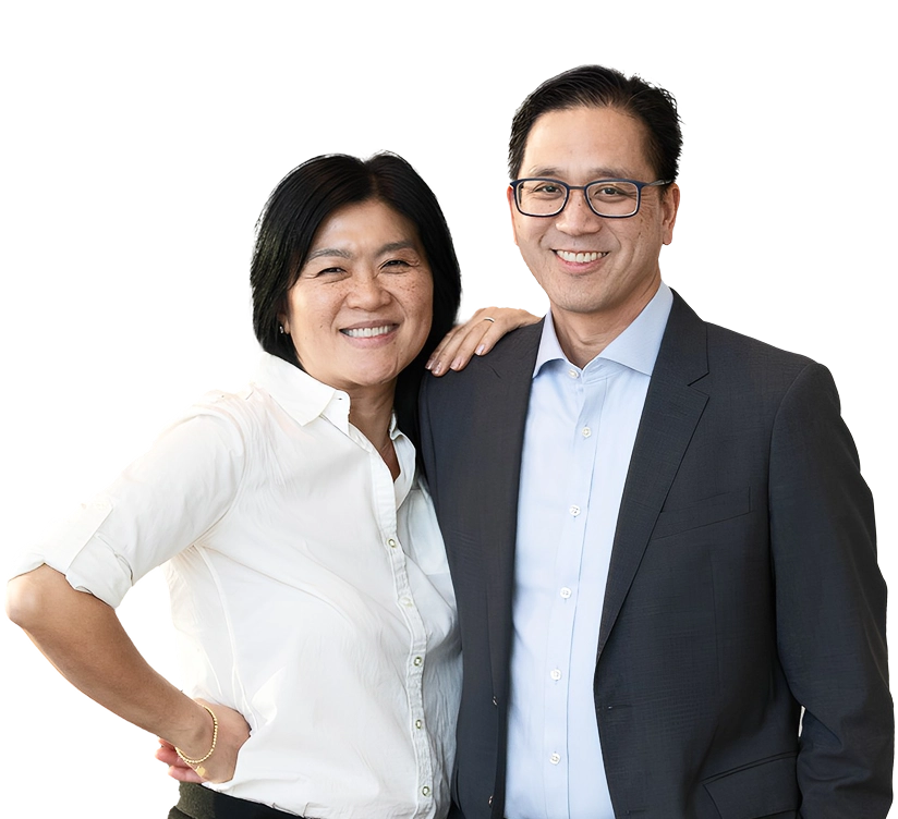 Dr. Marn standing with his wife, both smiling and posing together.