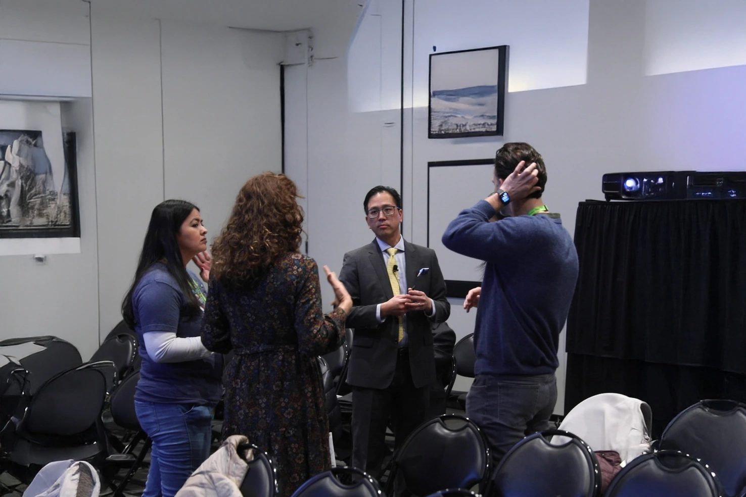 Dr. Marn in conversation with conference attendees during a networking session.