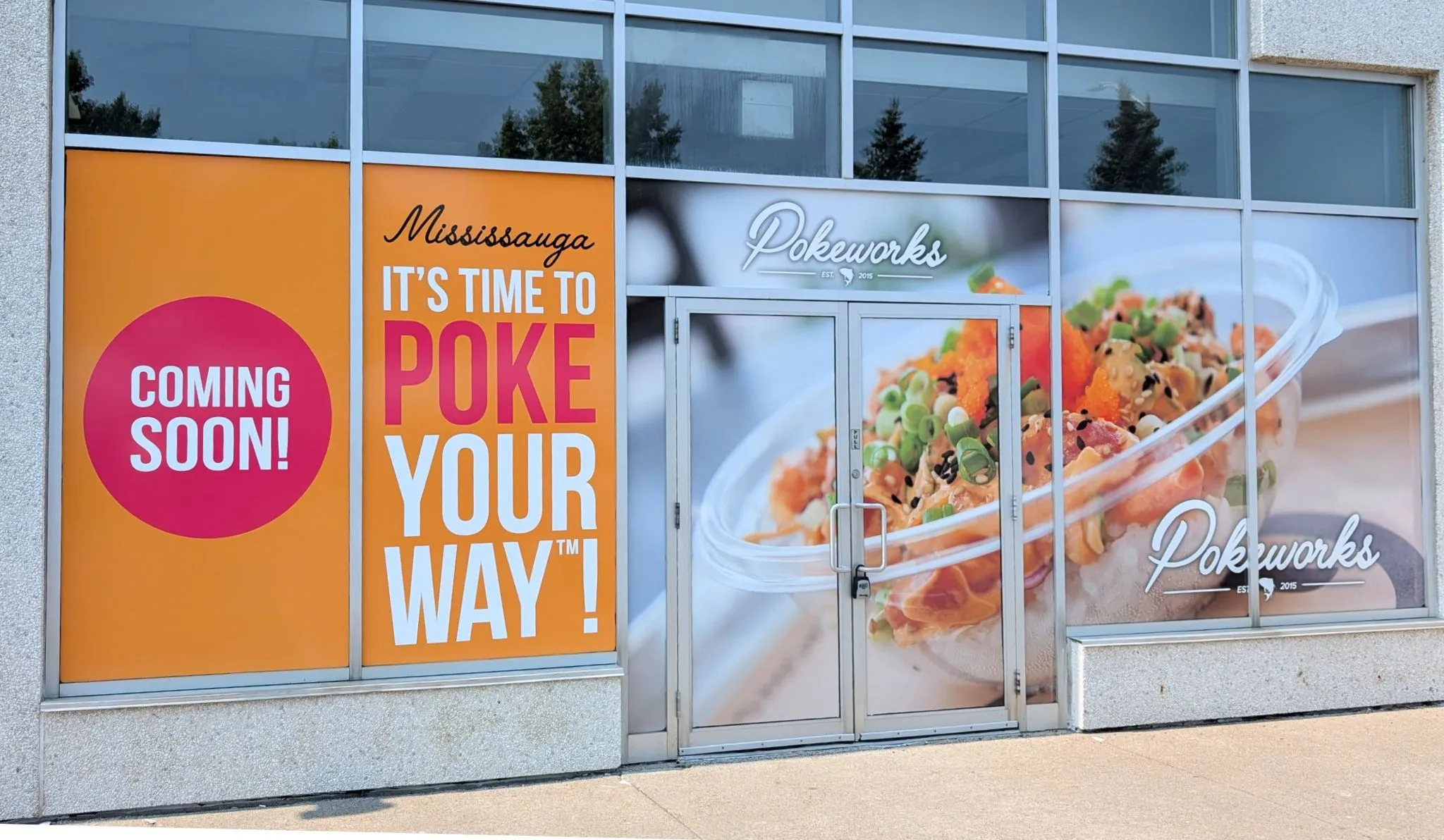 Pokeworks Mississauga custom window vinyl decals and hoarding graphics designed and installed by Resource Integrated in 2025.