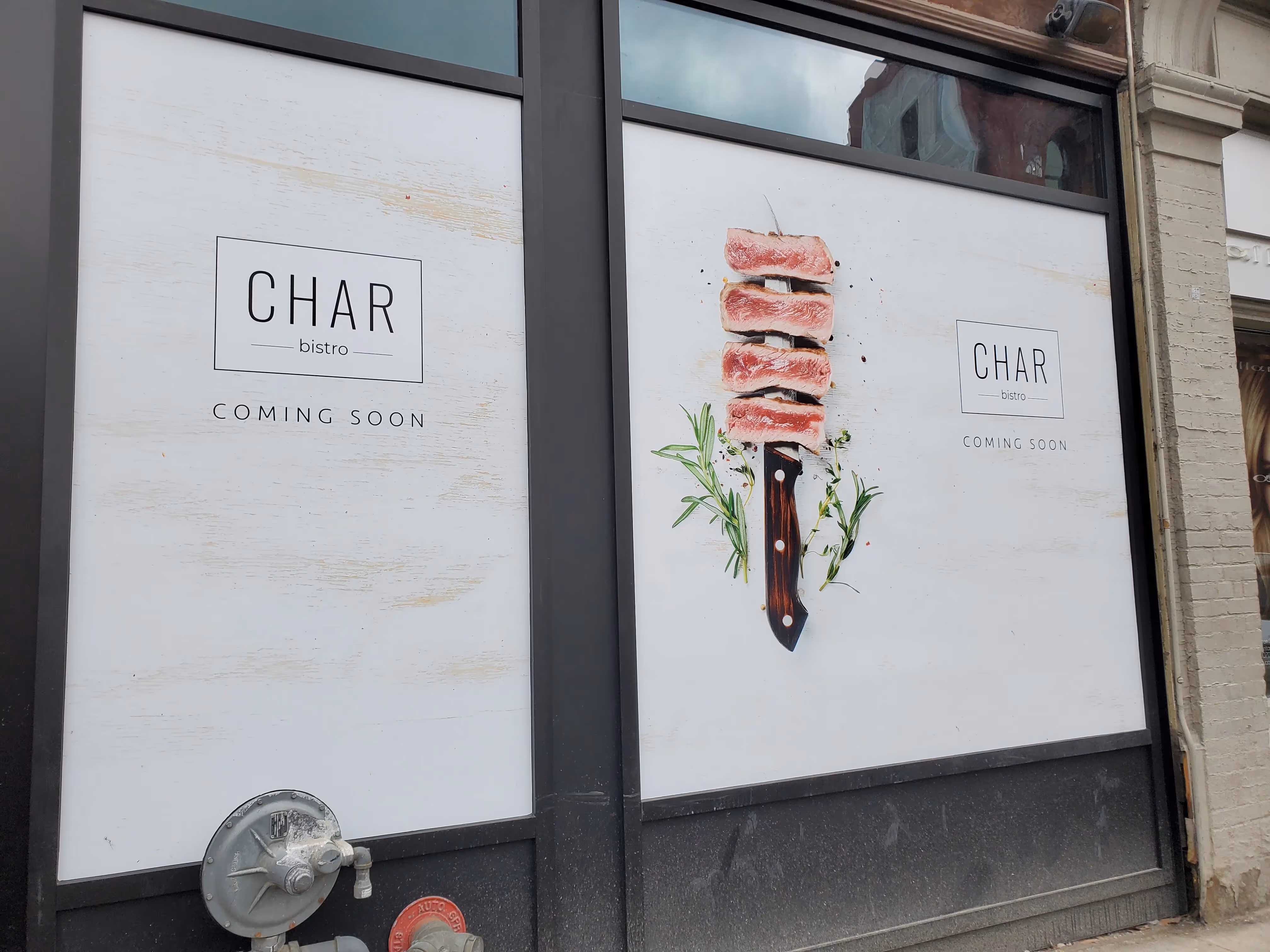 Char Bistro "Coming Soon" window decals installed by Resource Integrated.