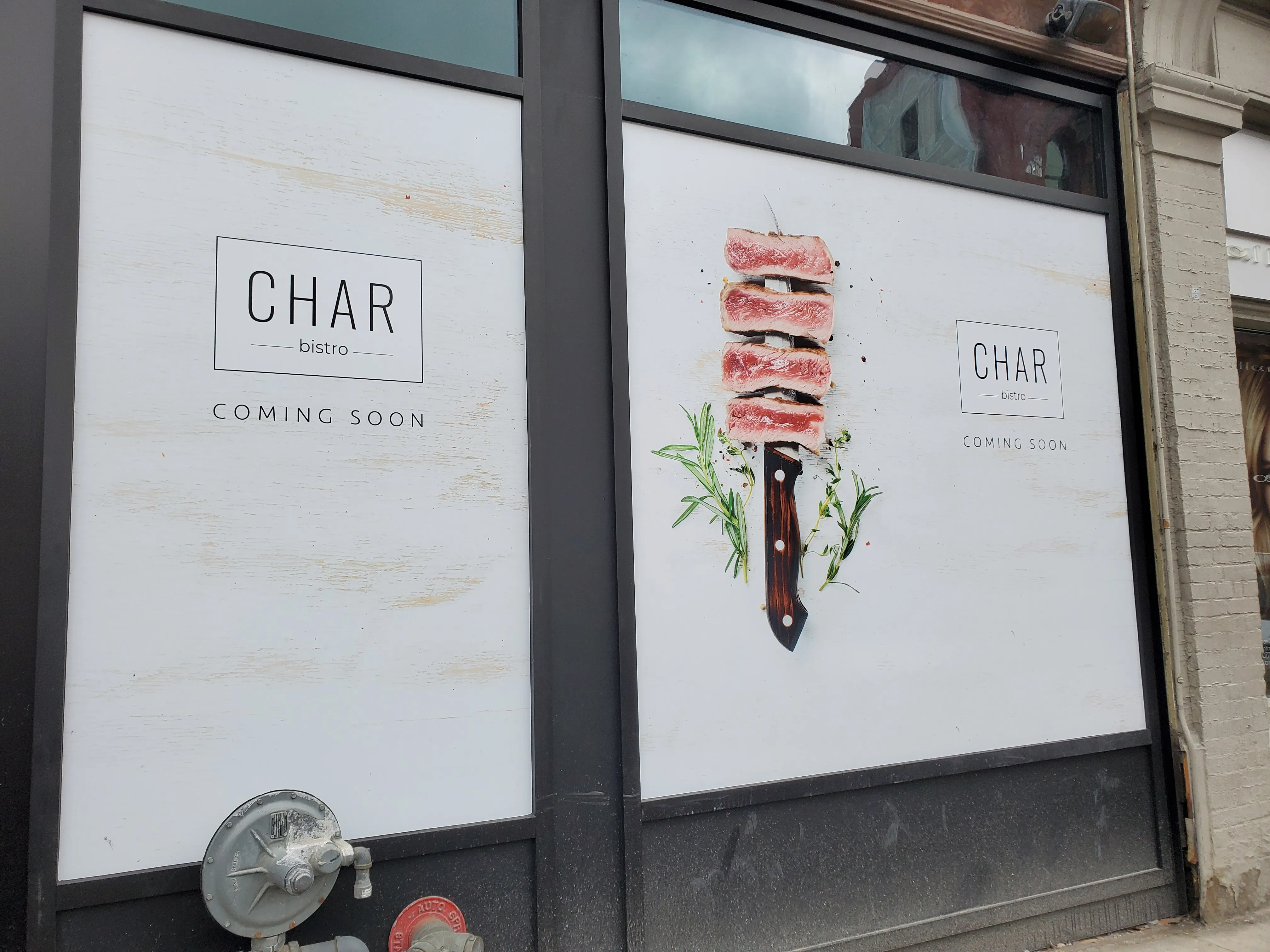 Char Bistro "Coming Soon" window decals installed by Resource Integrated.