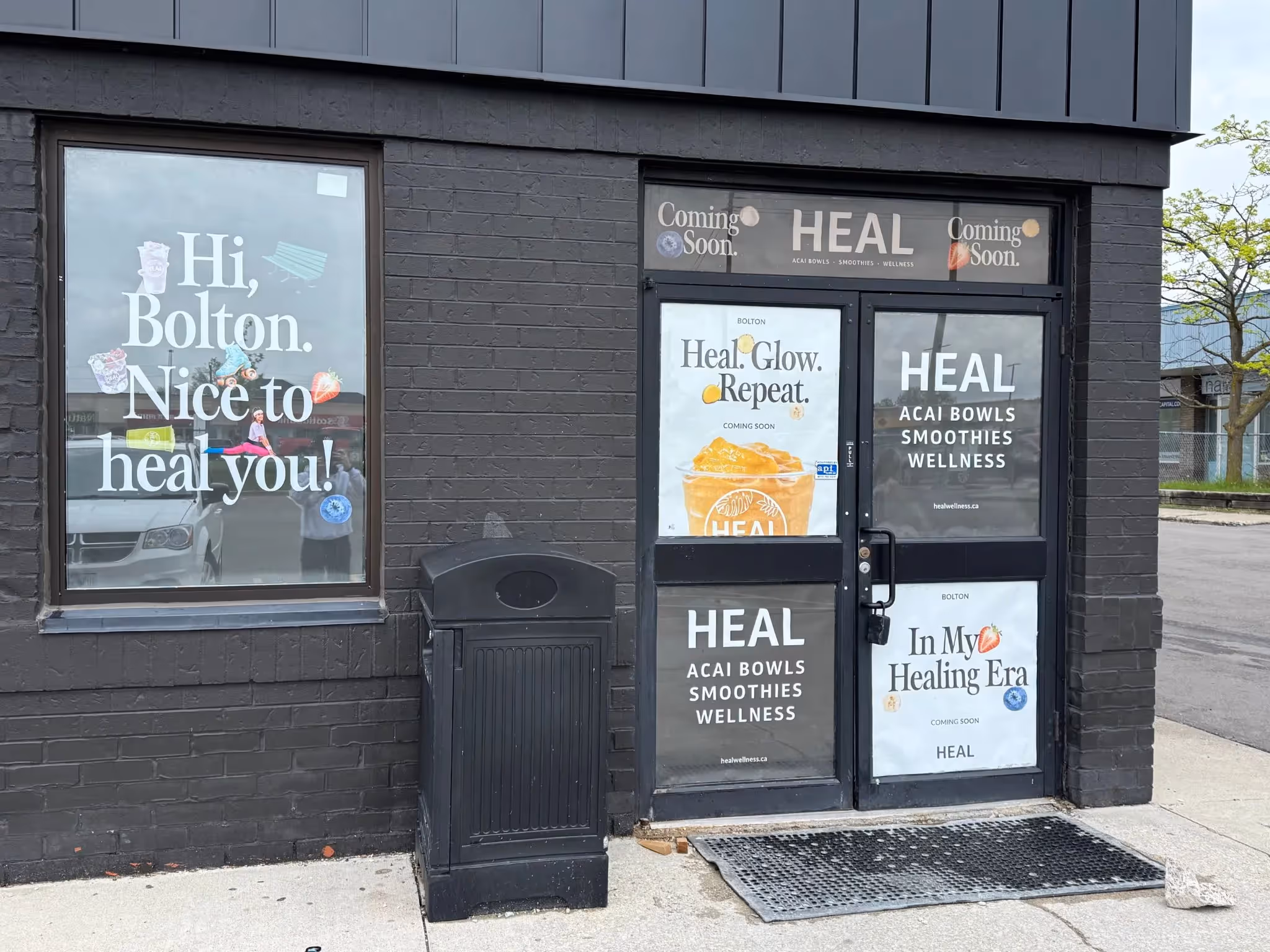 HEAL Bolton storefront window decals installed by Resource Integrated in 2025 featuring wellness branding.