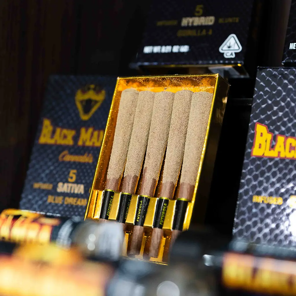 Close-up of cannabis pre-roll infused with concentrate, showing sticky resin.