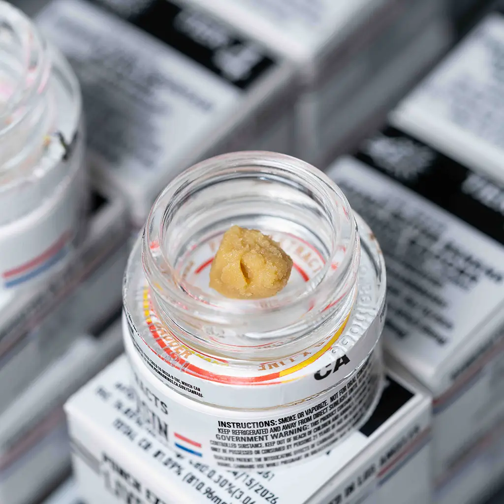 Golden cannabis sauce with visible terpene-rich crystals.