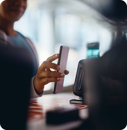 Gym member checking in with mobile phone