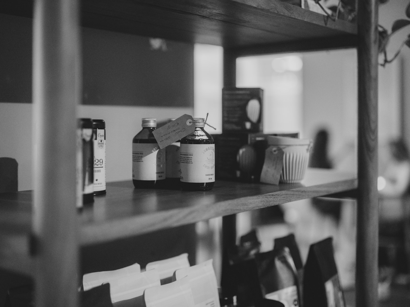 Labeled bottles on a wooden shelf