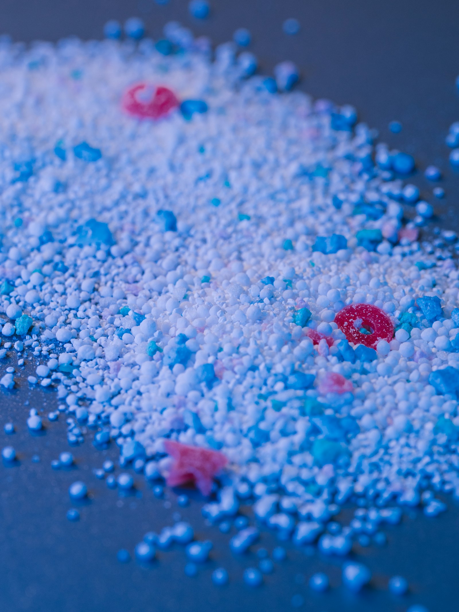 Colored plastic resin granules scattered on a surface