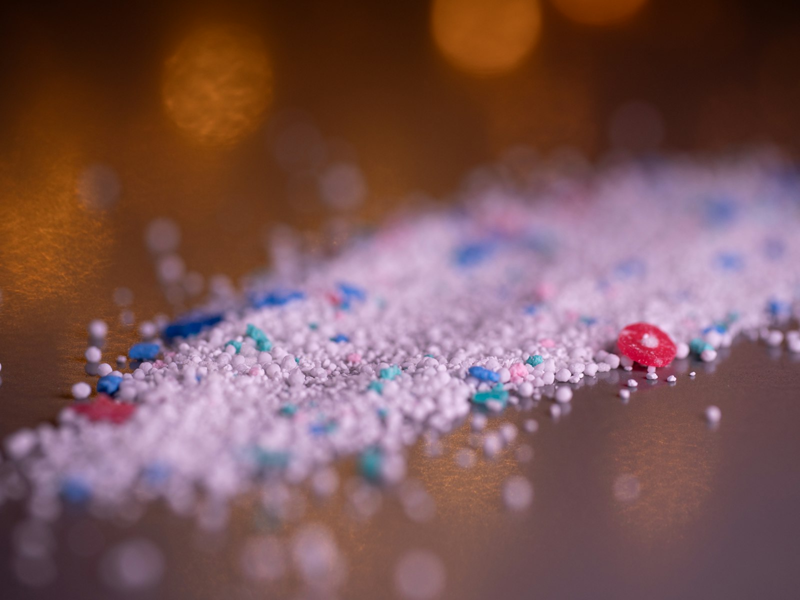 Recycled plastic granules piled on a surface