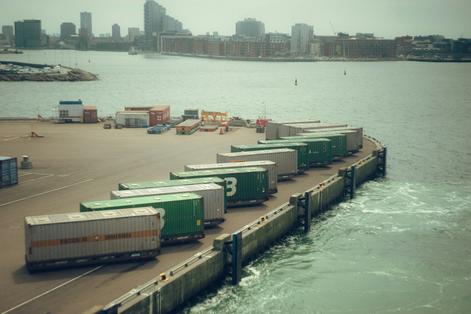 Shipping containers lined up at a busy port