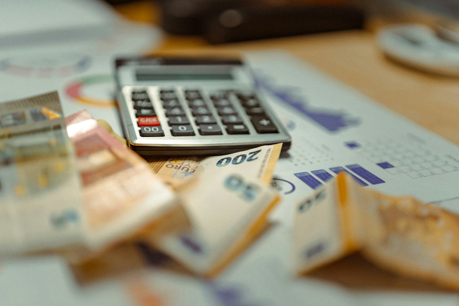 Calculator sitting on top of a pile of money