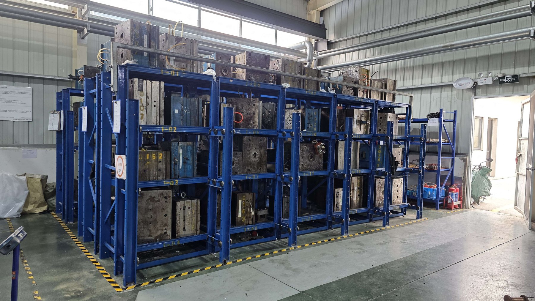 Rows of injection molds stored on racking at Jadewell's factory