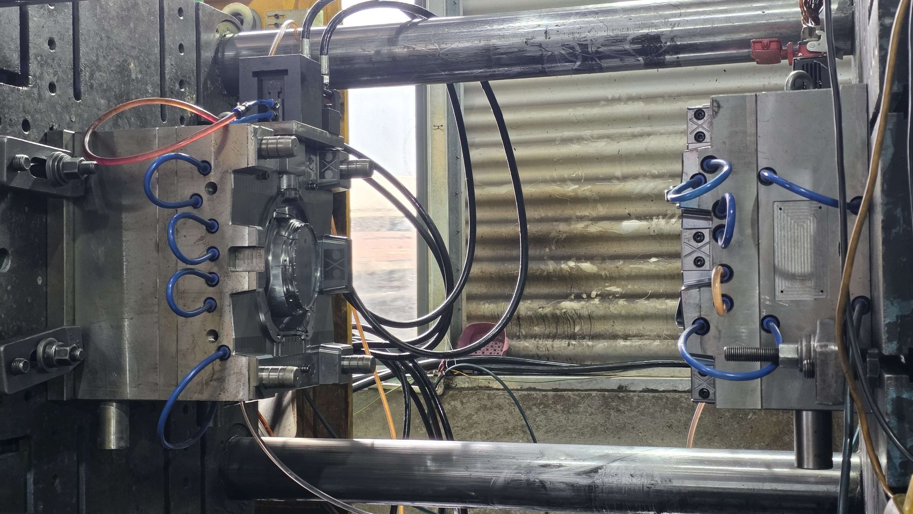 Injection mold tooling mounted in a press at Jadewell's plastic packaging factory