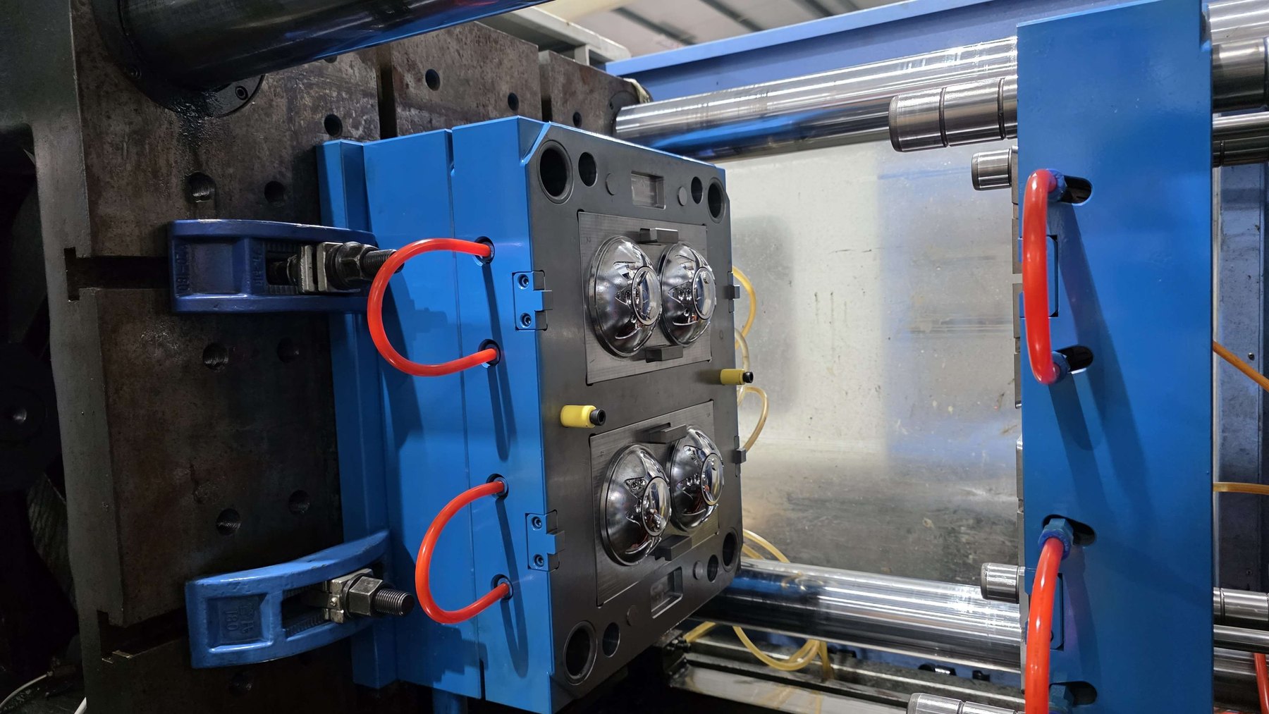 Injection mold open in the press with the cooling circuit connected at Jadewell's factory