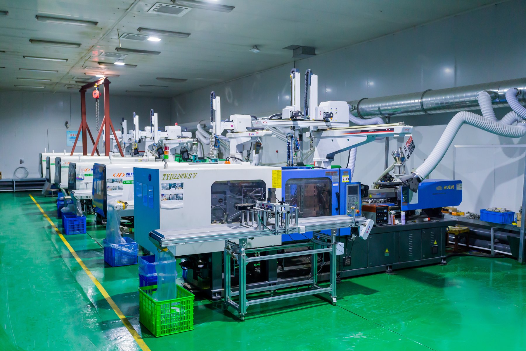Injection molding machines with take-out robots on Jadewell's production floor