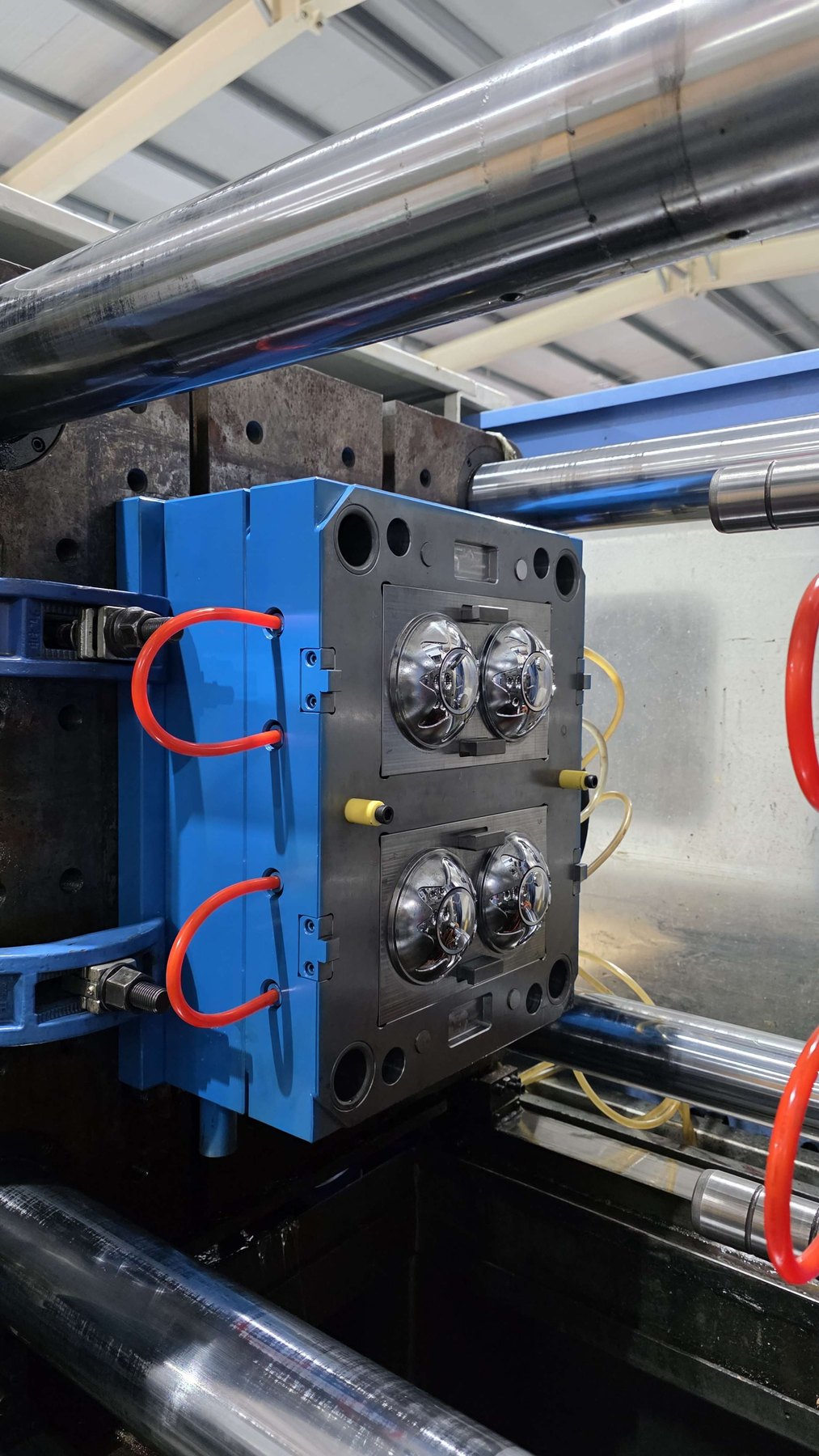 Polished injection mold cavities inside a press, where a soft-touch closure substrate is molded