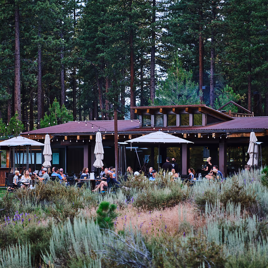 A group of people sitting outside of a building.