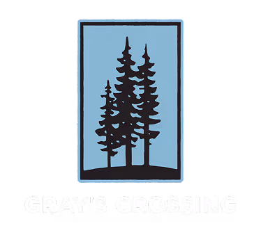 Logo featuring three black pine trees inside a blue rectangular frame above the text 'GRAY'S CROSSING'.