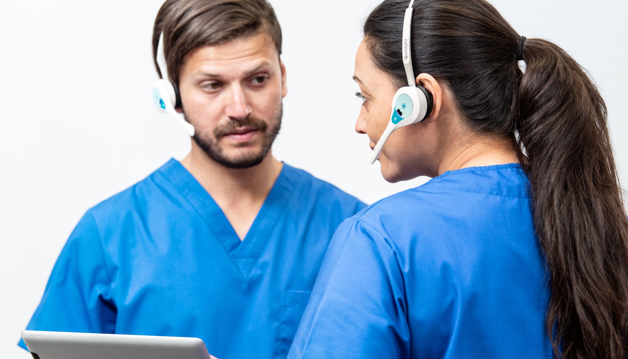 Two Healthcare Professionals Communicating Whilst Wearing Quail Digital Pro11 Wireless Headsets