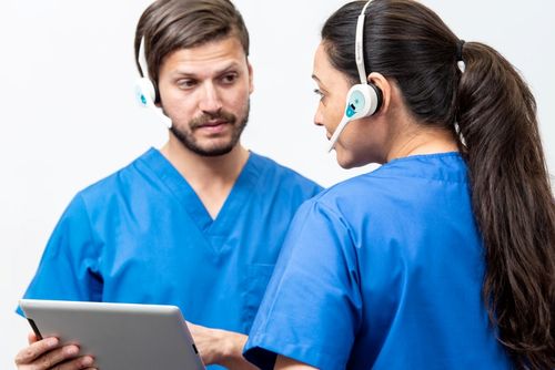 Two Healthcare Professionals Communicating Whilst Wearing Quail Digital Pro11 Wireless Headsets