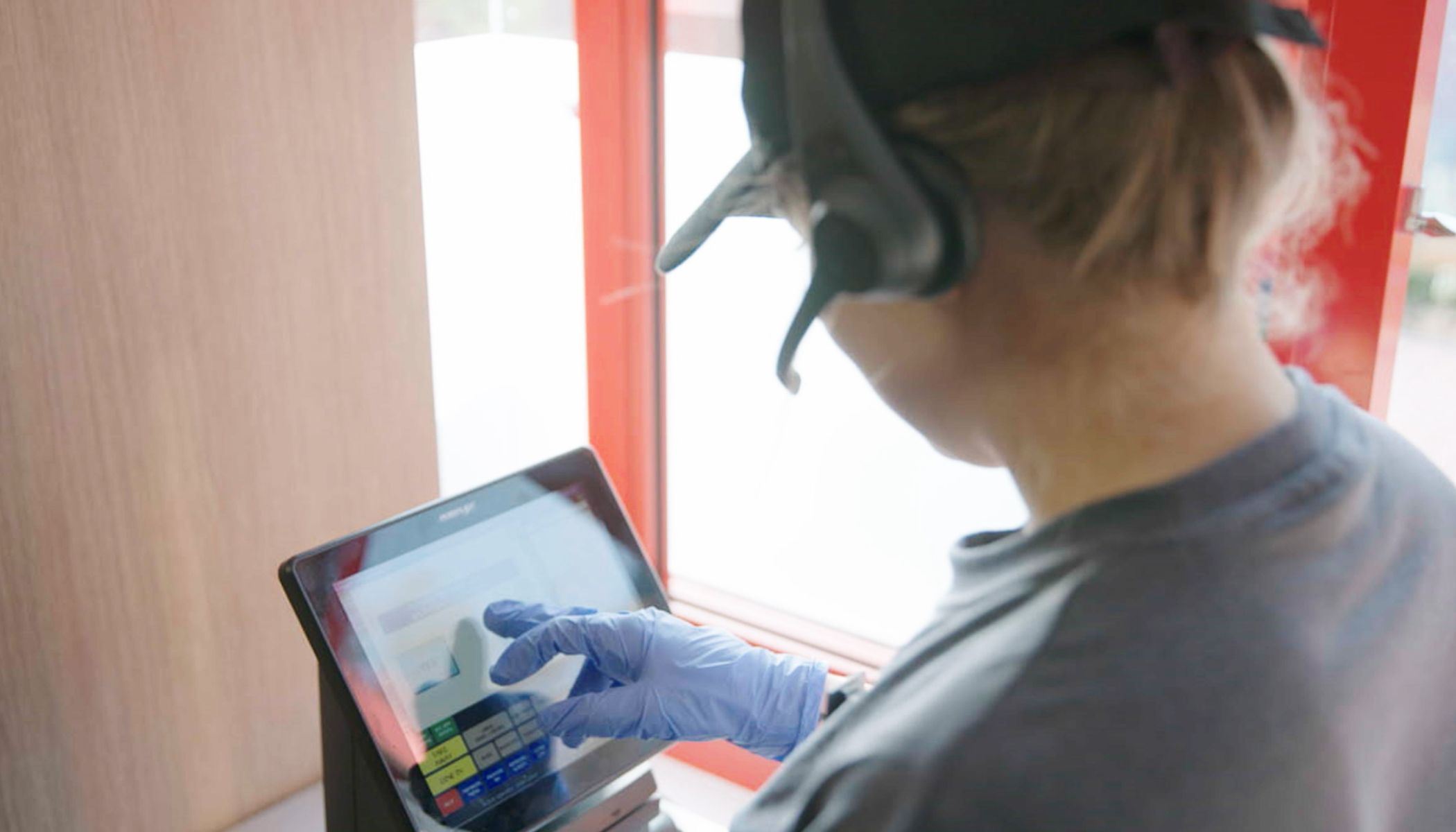 Woman Taking Orders at Drive-Thru with Headsets Usage