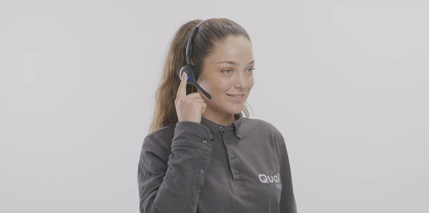 Female pressing headset - using PTT feature on Pro12 Headset