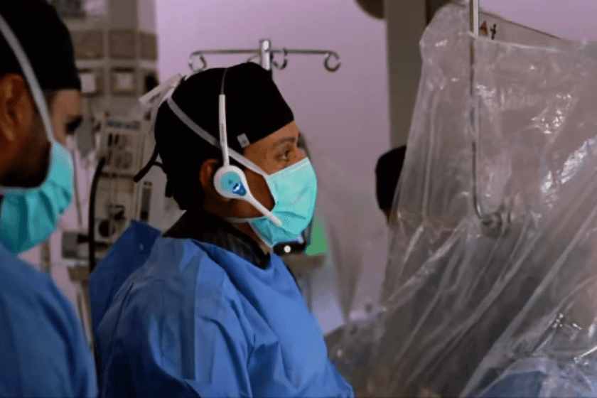 Surgeon in a hospital operating thetre with Quail Digital Pro11 Headsets on