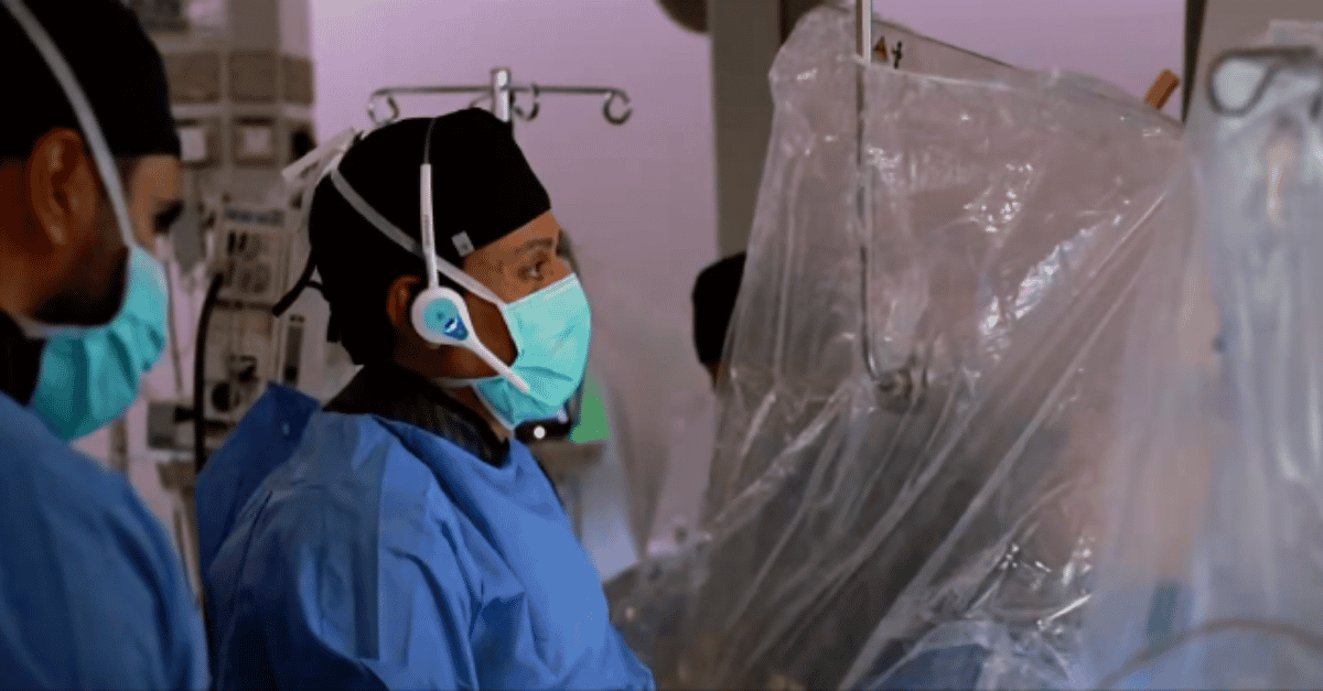 Surgeon in a hospital operating thetre with Quail Digital Pro11 Headsets on