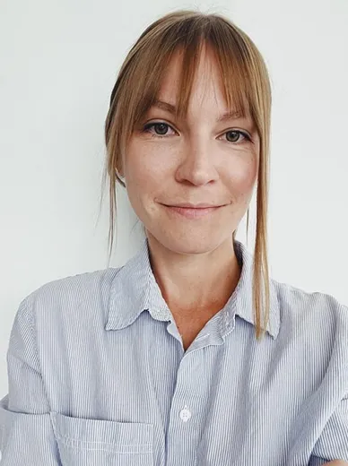 Portrait of same woman smiling slightly

