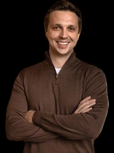 Another portrait of smiling man in brown outfit

