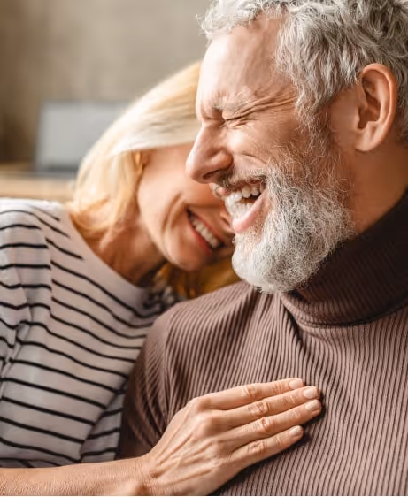 Happy mature couple sharing a close, affectionate moment, representing improved intimacy and confidence from GAINSWave® shockwave therapy.