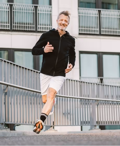 Older man jogging outdoors with energy and confidence, representing the benefits of Testosterone Replacement Therapy at Gameday Men’s Health.