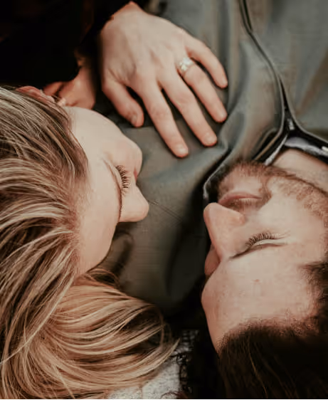Happy couple laying together and smiling, representing improved intimacy from Viagra and Cialis treatment