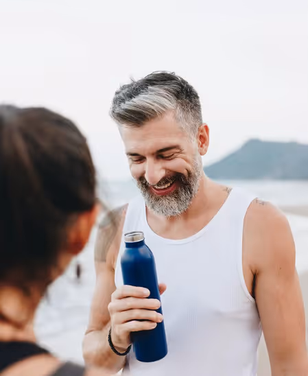 Man drinking water after outdoor workout representing renewed energy from Sermorelin Peptide therapy