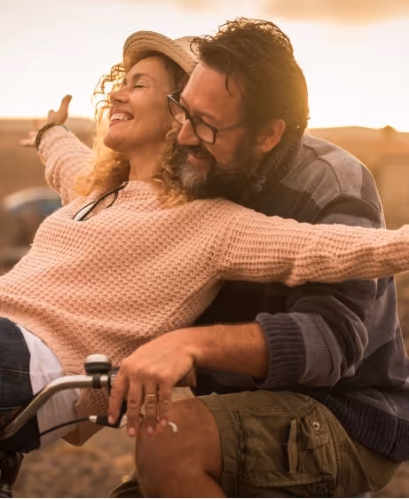 Smiling couple enjoying a sunset bike ride symbolizing renewed confidence with Trimix