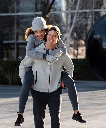 Couple laughing together on a city street, illustrating benefits of oral testosterone for men